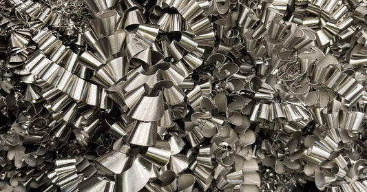 A large number of Inconel metal shavings in the shape of spirals. They are all piled on top of one another.