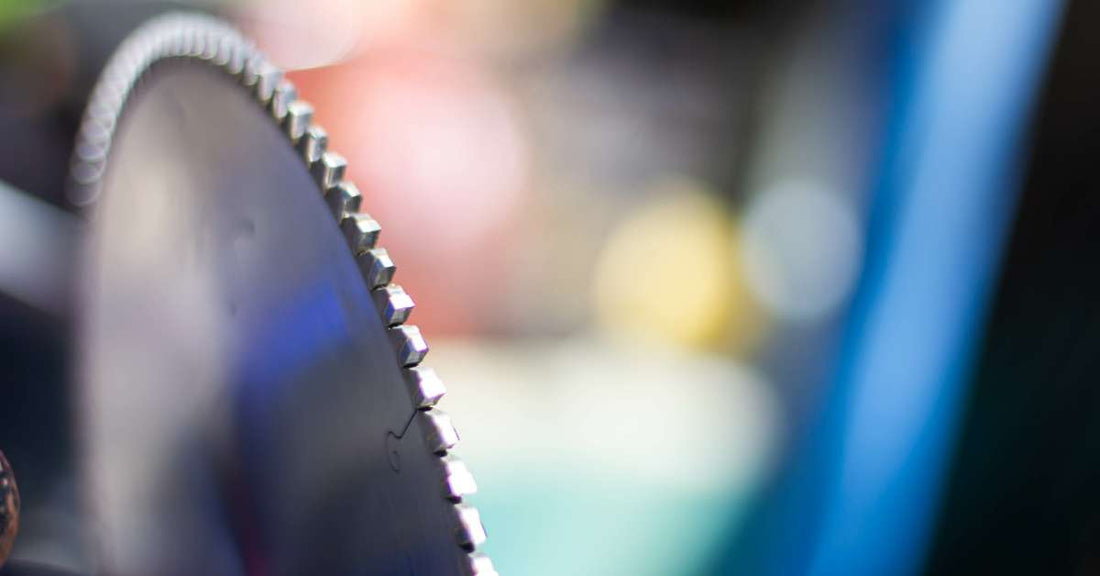 A cold saw circular blade for metalworking. The light is reflecting off the shiny edges of the blade's teeth.